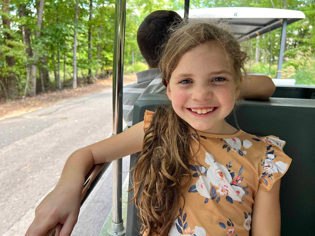 girl riding tram at zoo