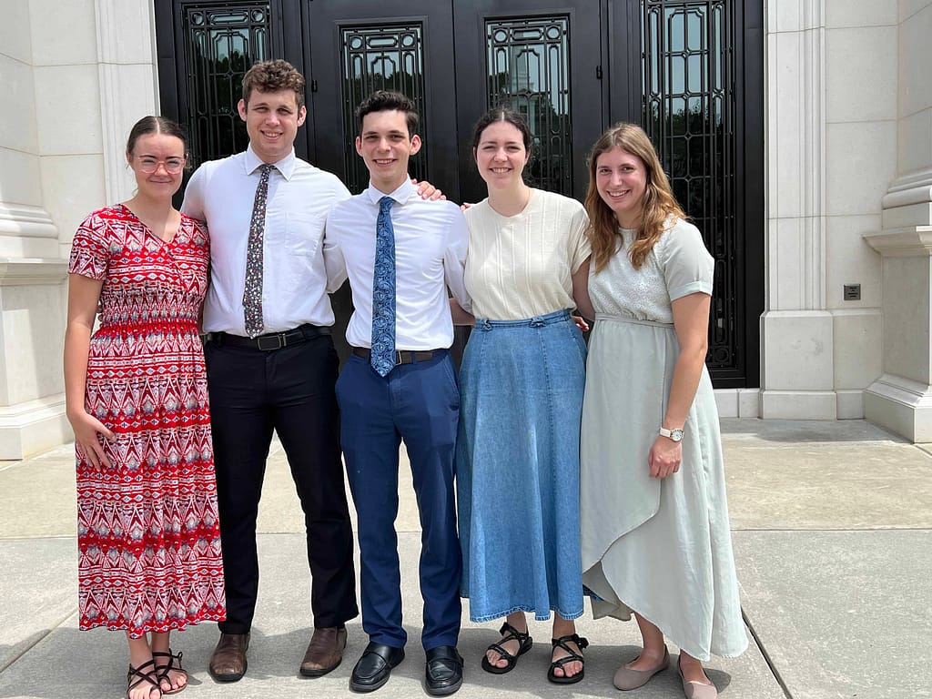 5 young adult siblings in Sunday clothes