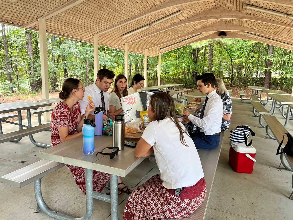 family at a picnic table in a pavilion