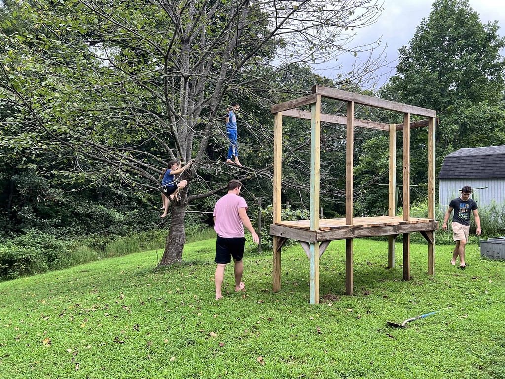 young men building an obstacle course
