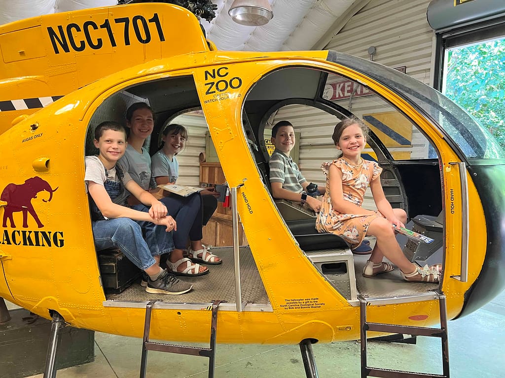 kids on pretend helicopter at zoo