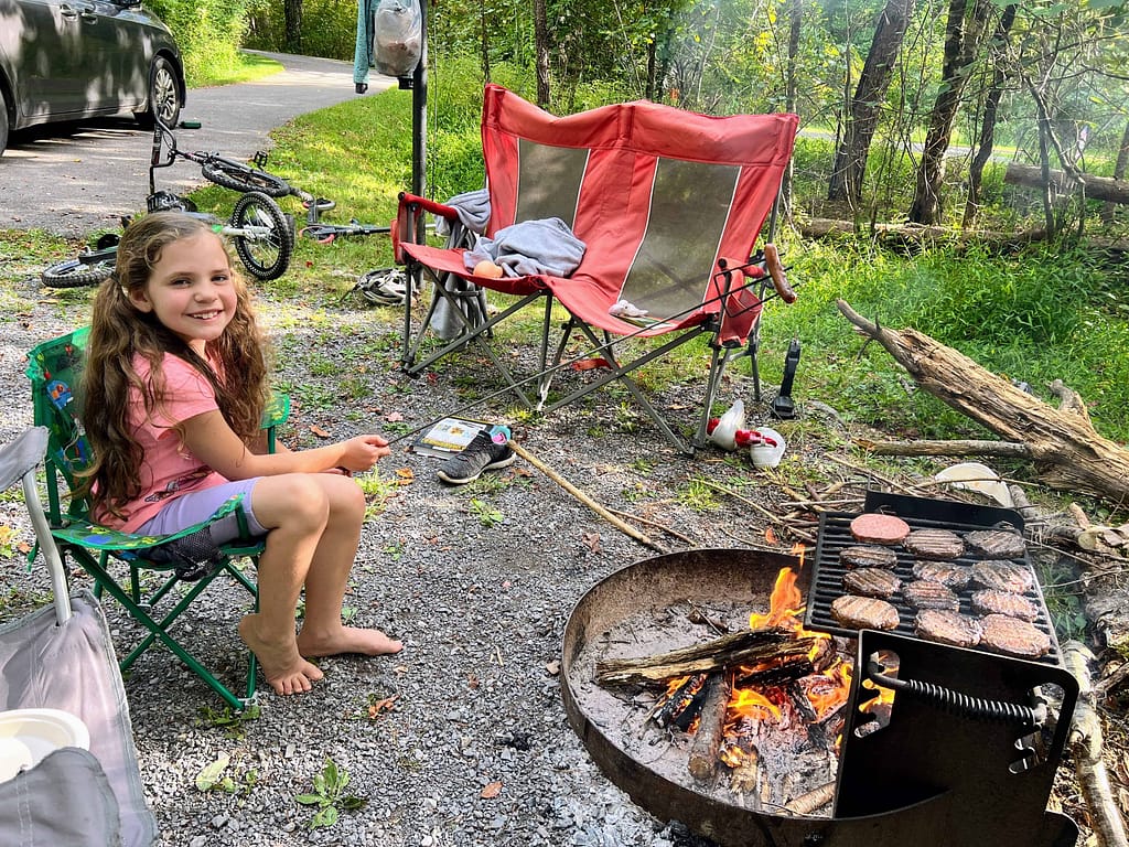girl roasting marshmallows over fire