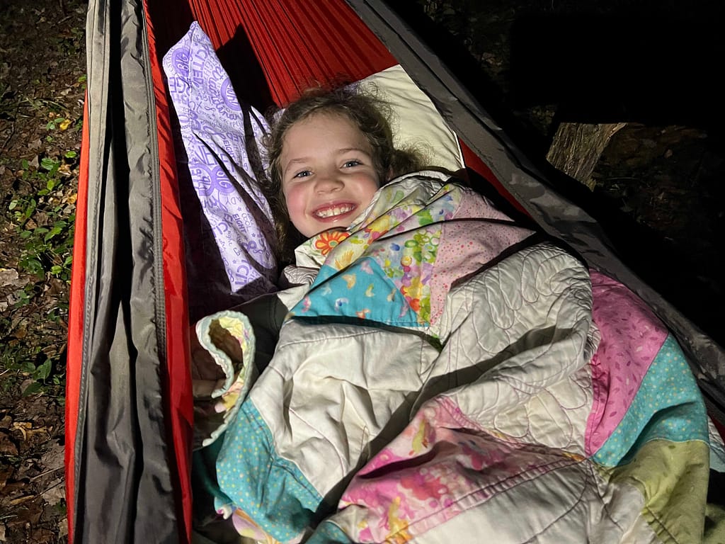 young girl sleeping in hammock