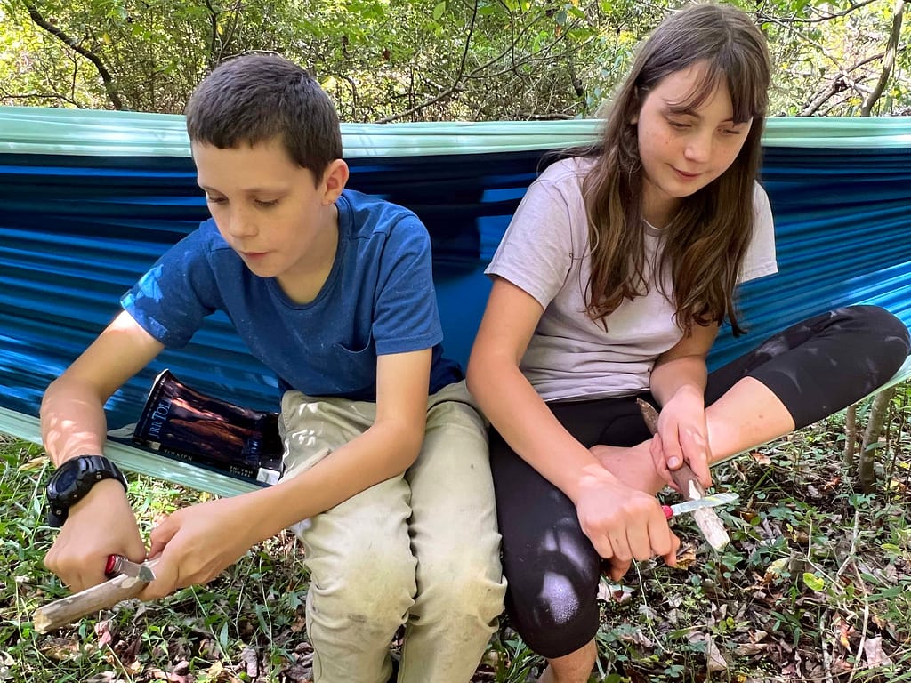 boy and girl carving in a hammock