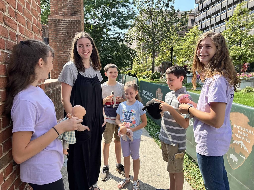 6 kids talking near Liberty Bell