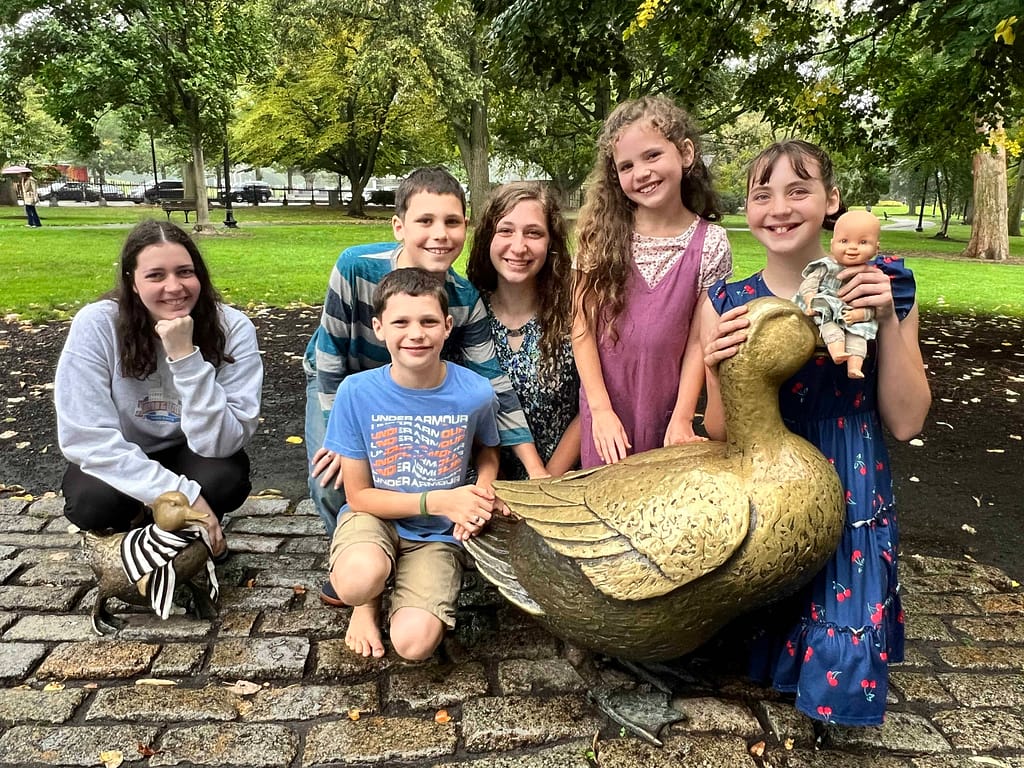 6 kids with duck statues
