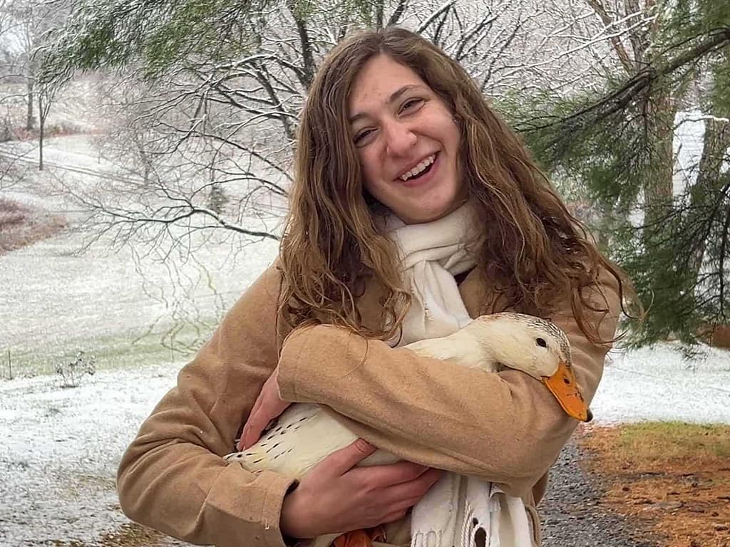 15 year old girl with duck in the snow