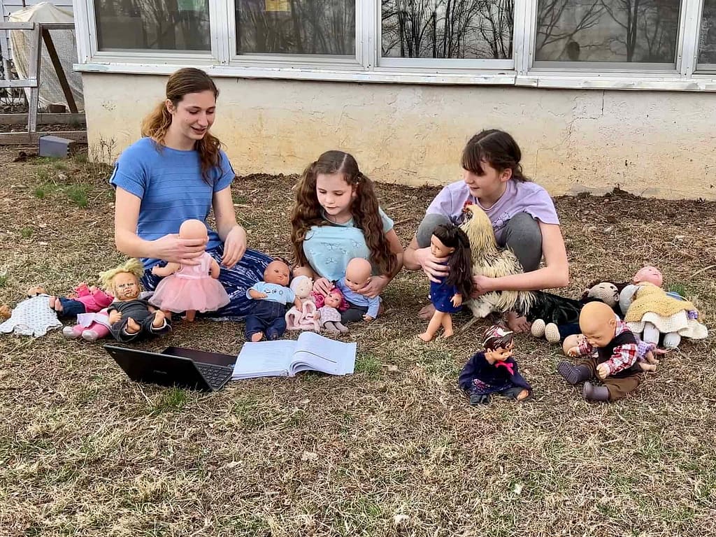 girls playing dolls outside