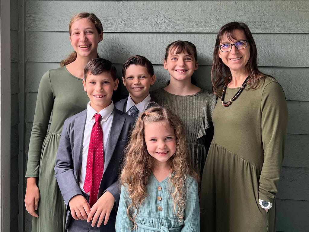 mom and 5 children wearing olive green church clothes for a picture