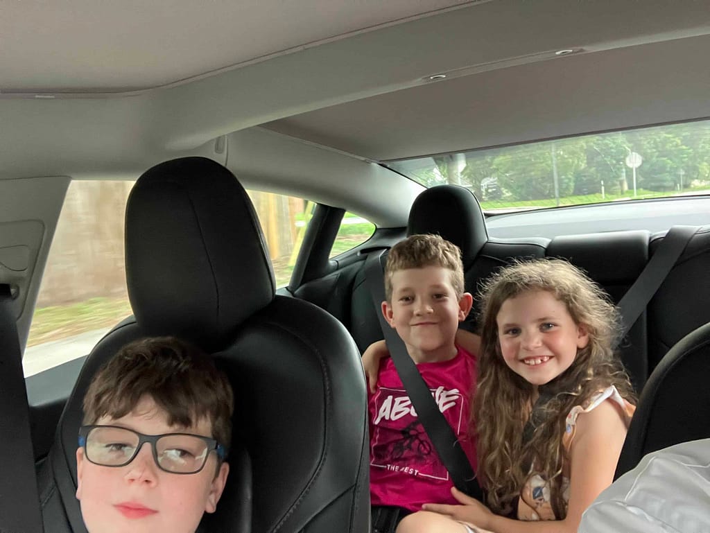 3 kids in a Tesla