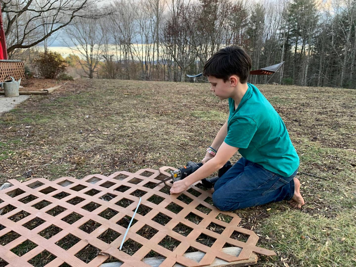 boy fixing some lattice