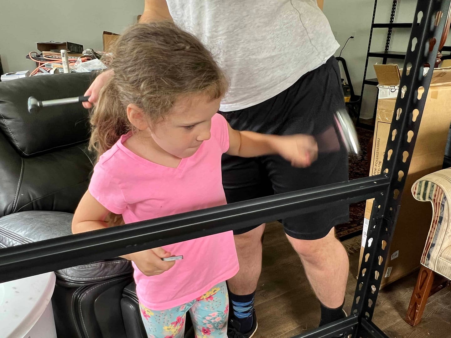 7 year old girl putting together a bookshelf