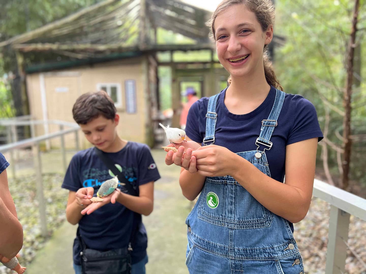 kids holding birds at the bird zoo