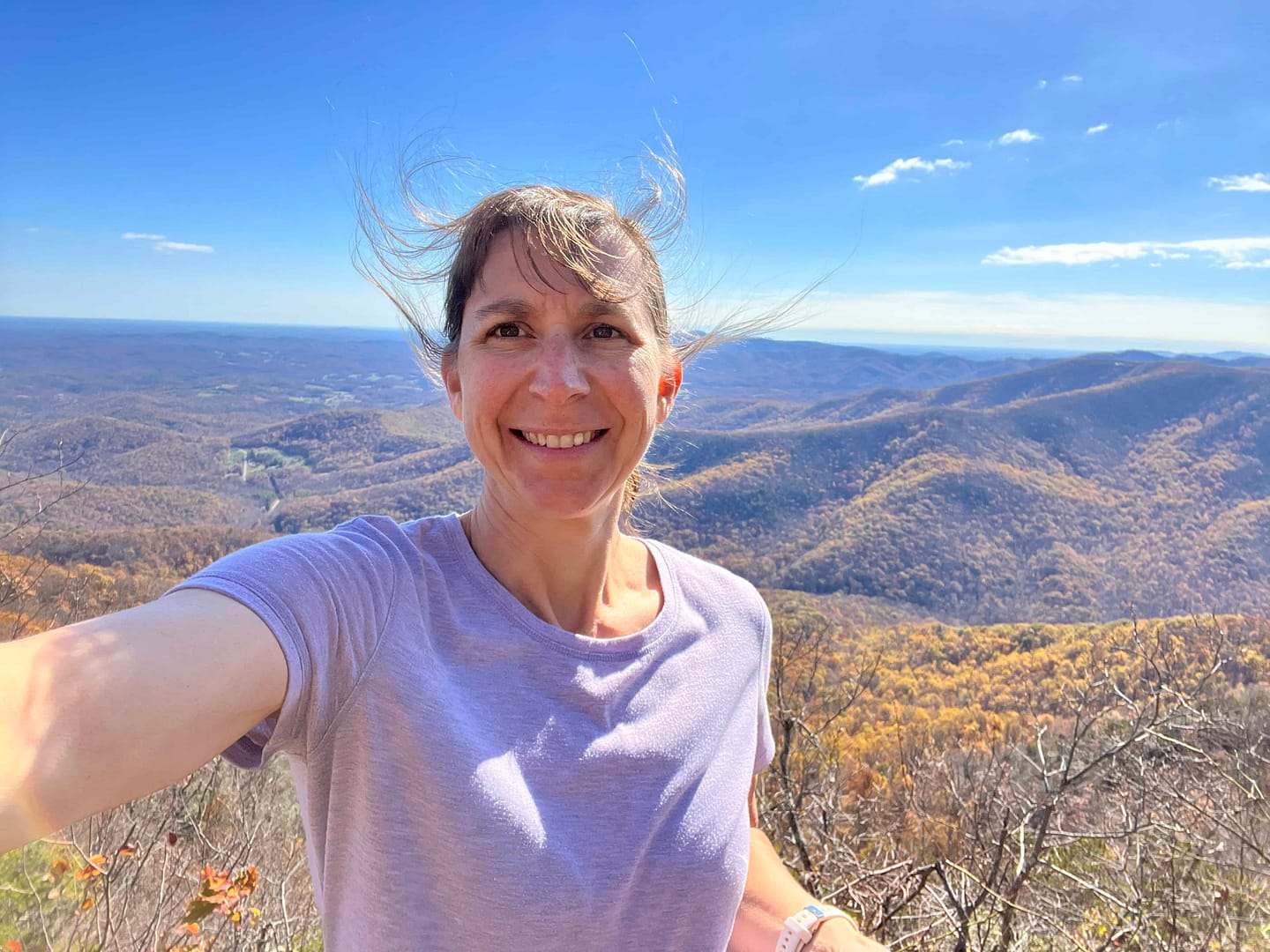 woman taking selfie with mountains behind her