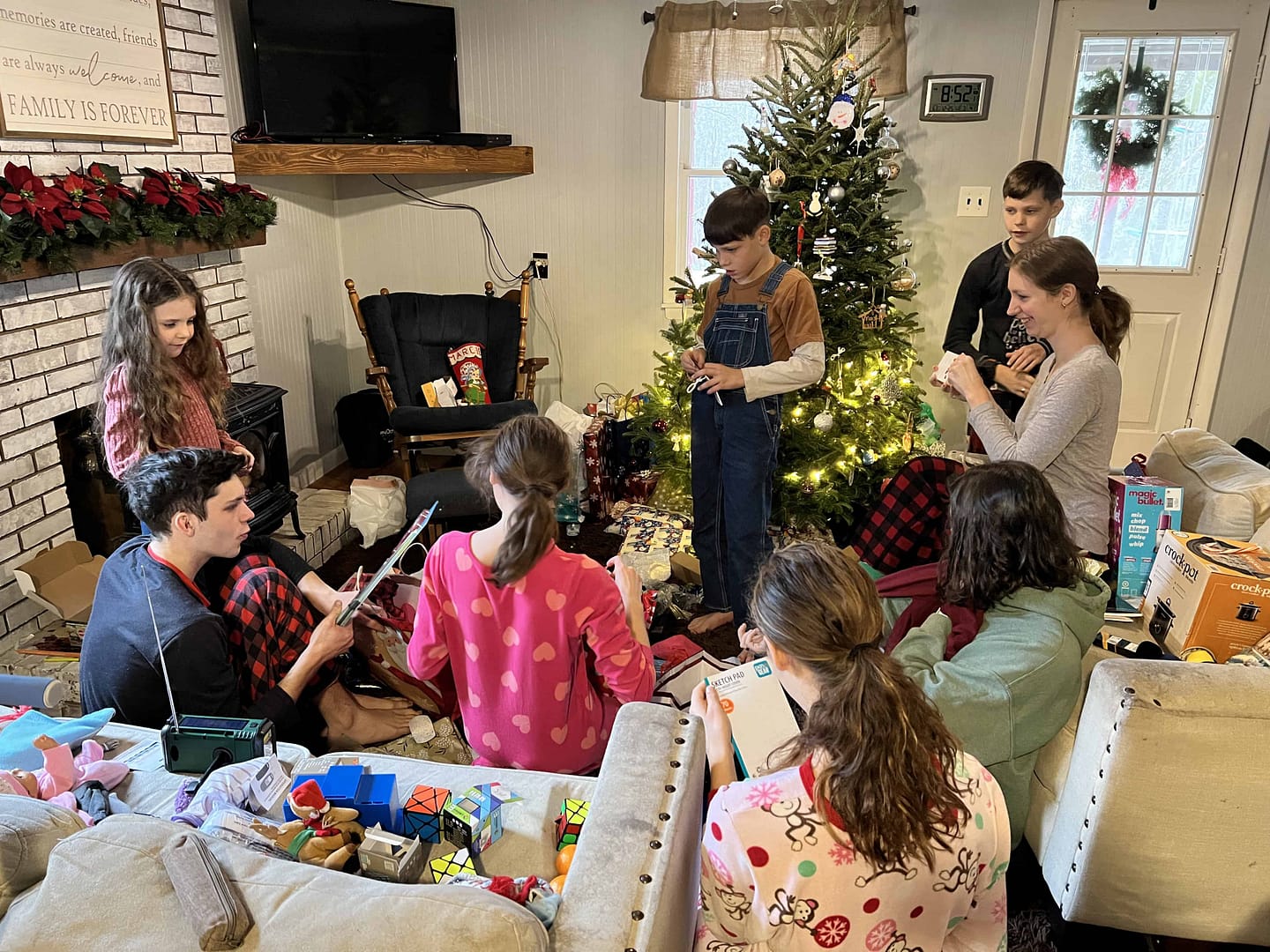 siblings opening presents on Christmas morning