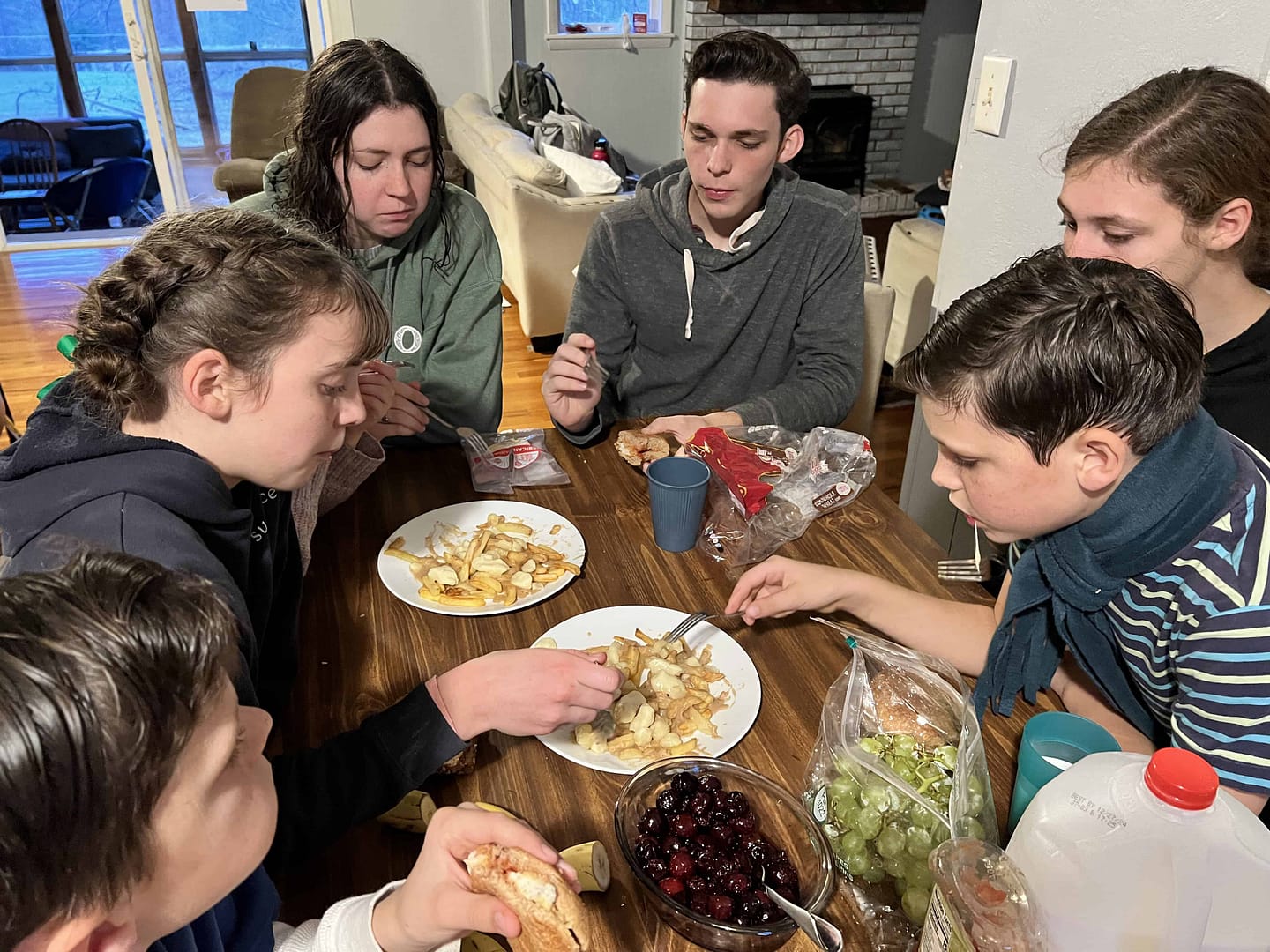 family eating poutine around the table