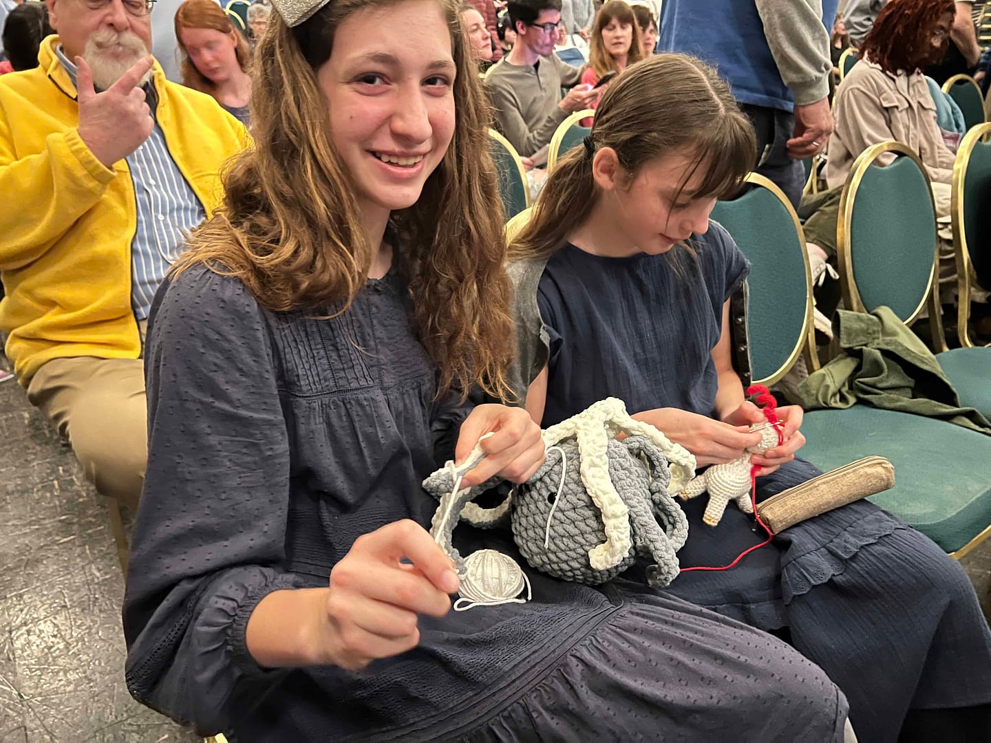 girls crocheting at a play