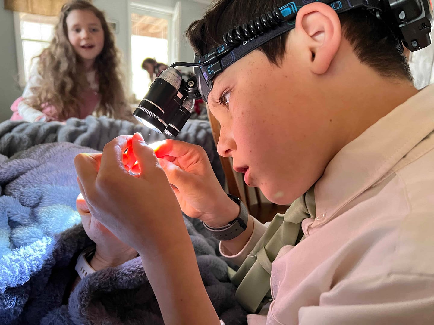 9 year old with head lamp on getting a splinter out