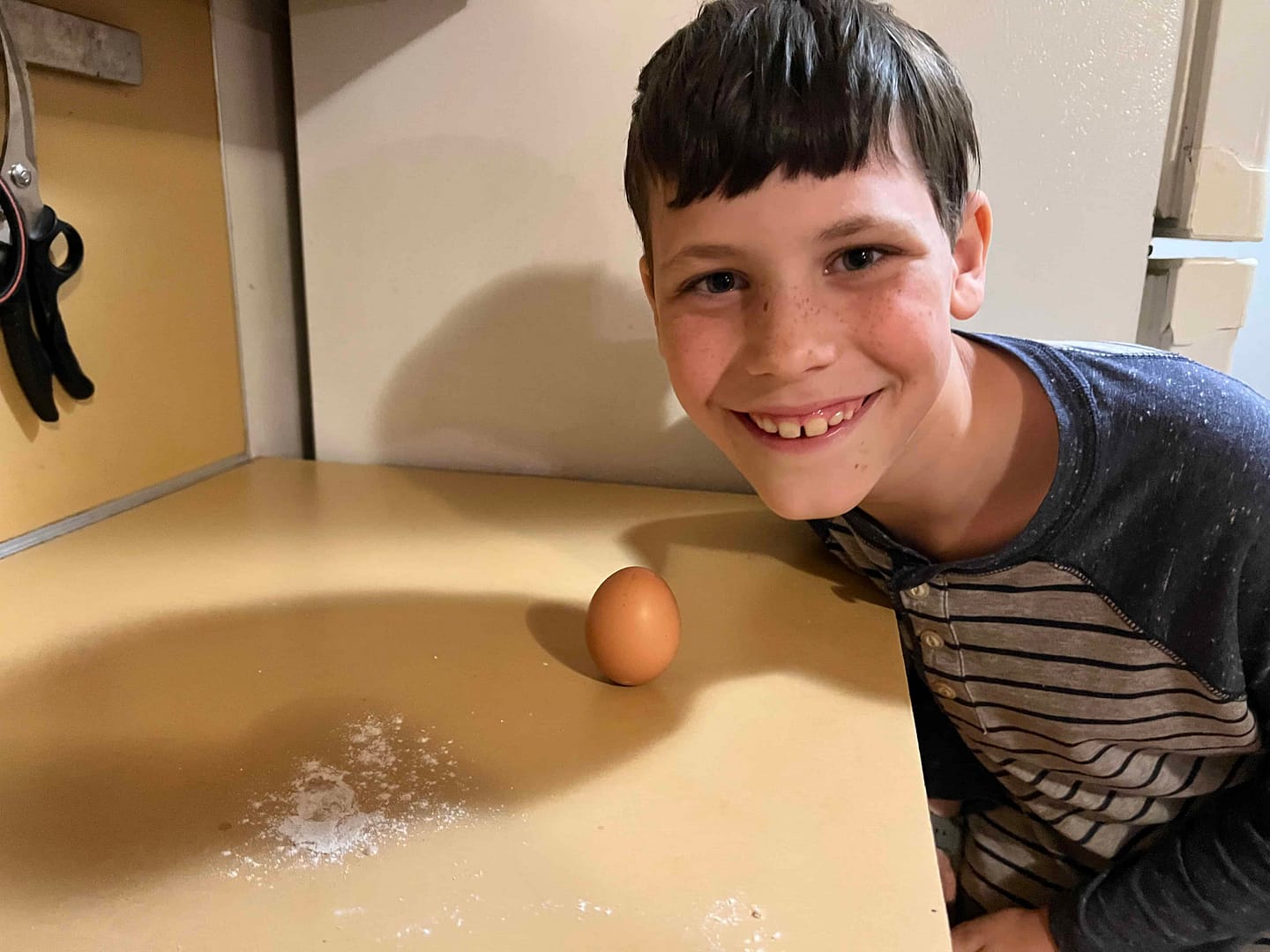 boy with egg balancing on the counter