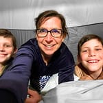 selfie of mom and 2 boys sleeping in tent