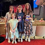 mom and daughters at a theater