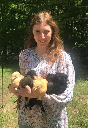 17 year-old girl holding 4 small chickens