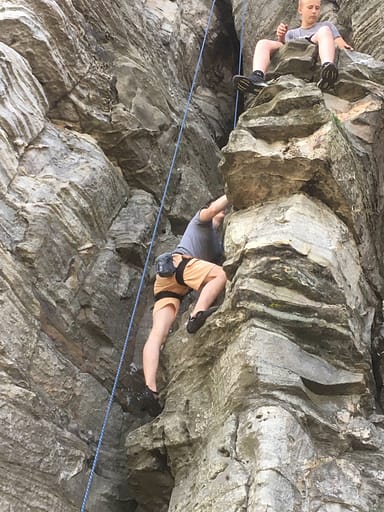 a boy rock climbing