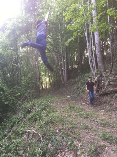 Boy swinging on a vine