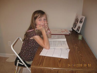 girl at desk at home doing end of grade state testing