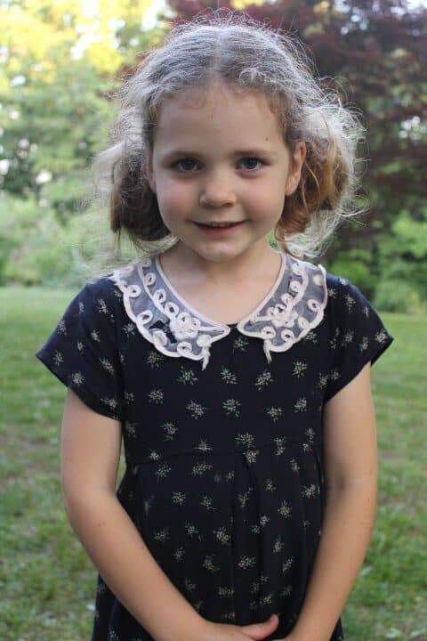 cute 5 year old girl wearing a navy dress