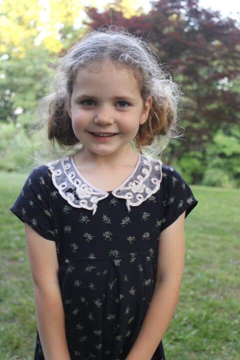 5 year old with pigtails smiles