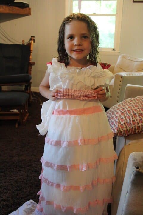 girl holding a Little Mermaid dress