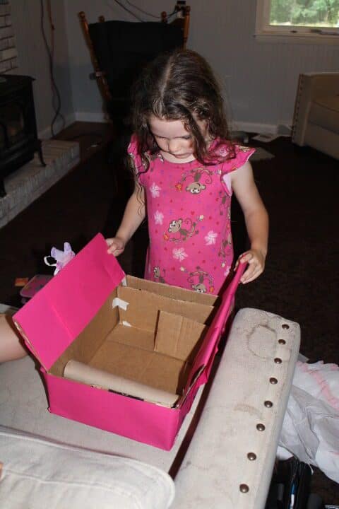 girl getting a cardboard closet for her birthday