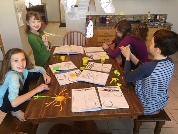 homeschool kids making neurons out of play doh for science as a memorable homeschool activity