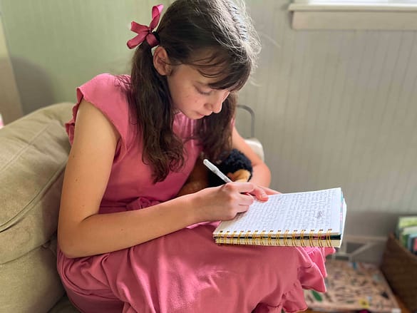 girl writing in her journal