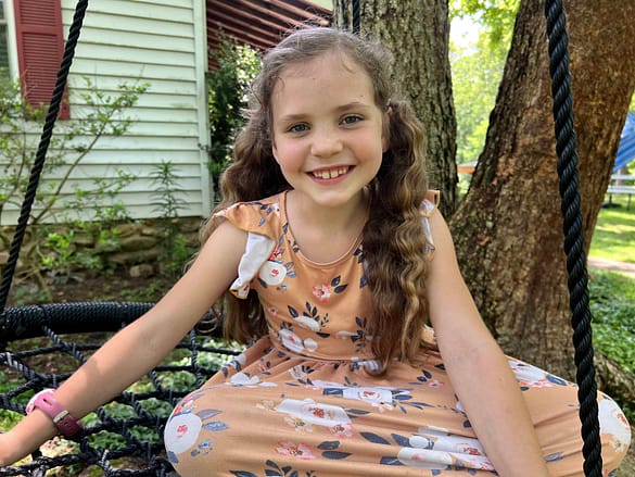 7 year old girl on a spiderweb swing