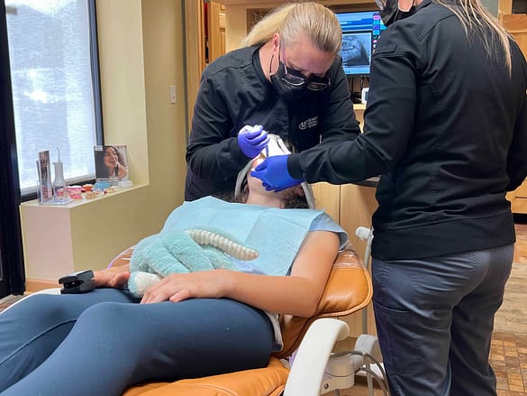 dentist extracting teeth from young teen