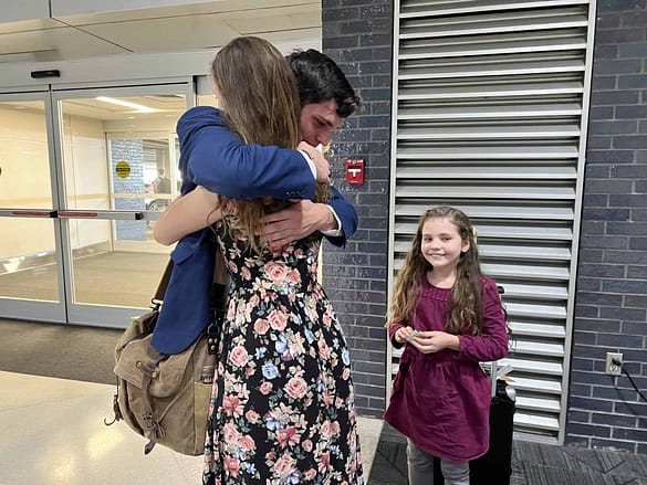 siblings hugging at airport