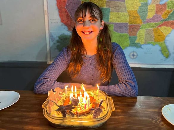 14 year old girl with birthday treat and candles