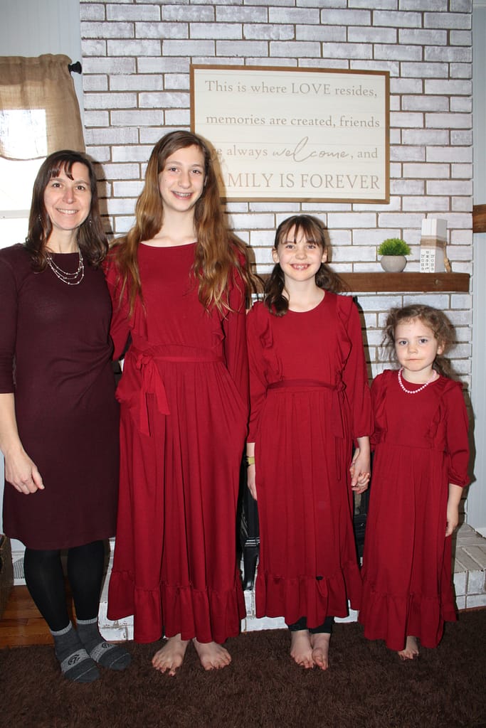 mom and 3 daughters wearing red dresses