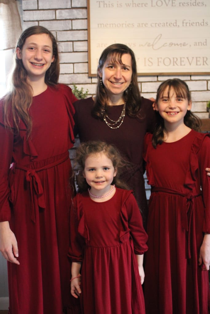 mom and 3 daughters dressed in red