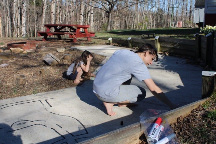 drawing roads on the concrete for toy cars
