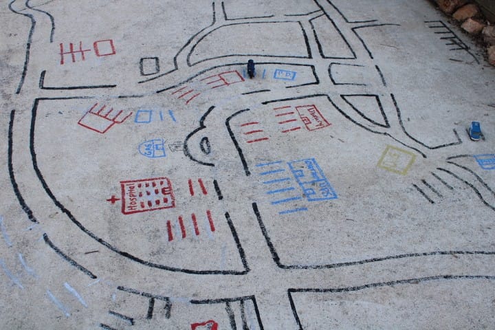 car roads drawn on concrete for matchbox cars