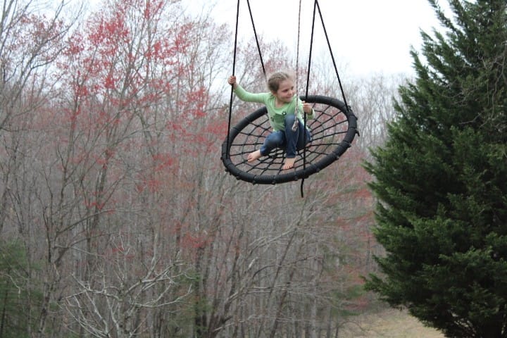 girl going high on the swing