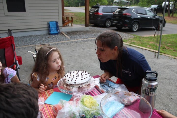 niece and aunt blowing out candles