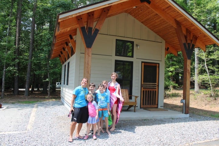 family in front of a cabin at Lake Norman