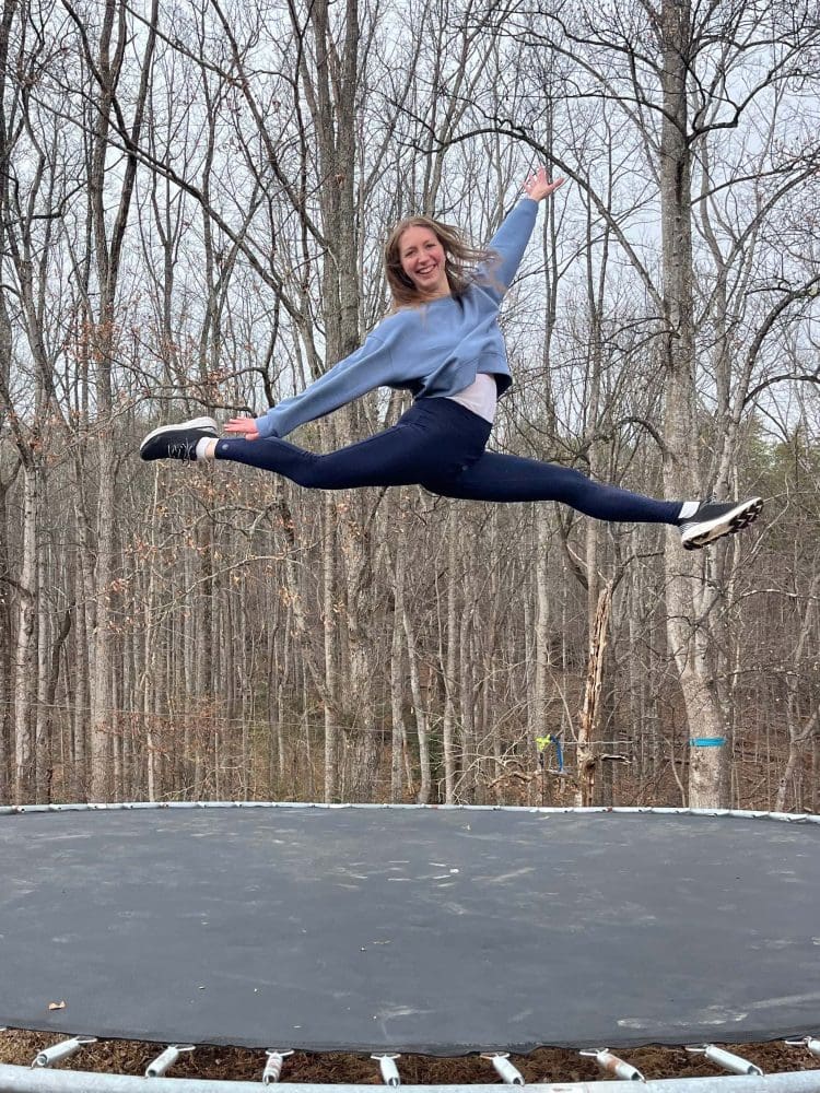 girl doing splits in the air over trampoline