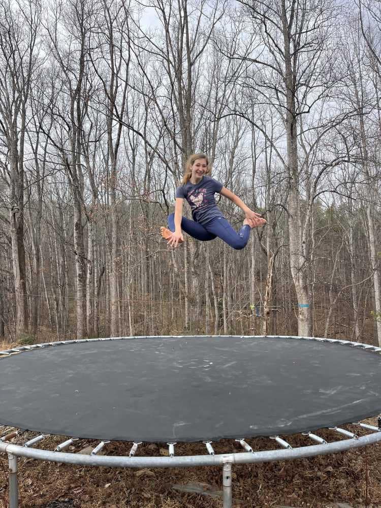 girl doing crazy jump on trampolilne