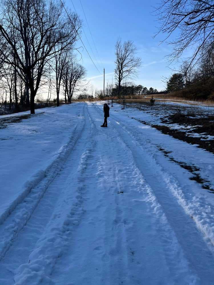 girl in snow covered driveway
