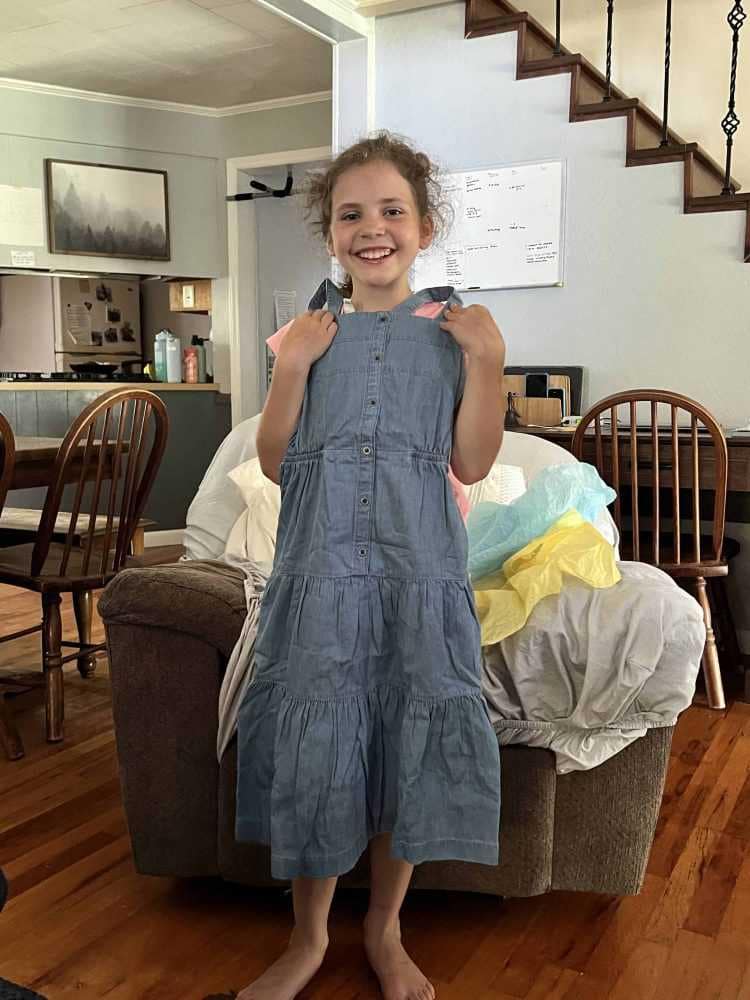 9 year old holding up a new dress